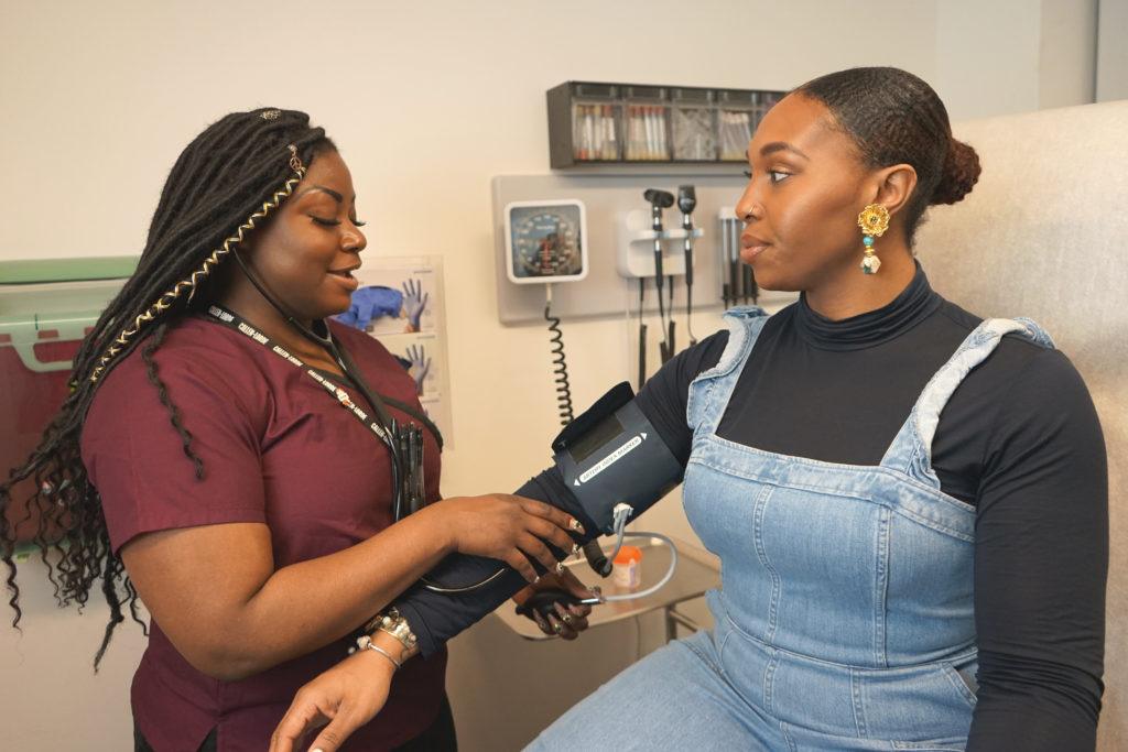 Nurse checking the blood pressure of a patient